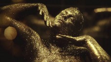 Nahé ženy odvážně ukazují svá těla pokrytá zlatým prachem